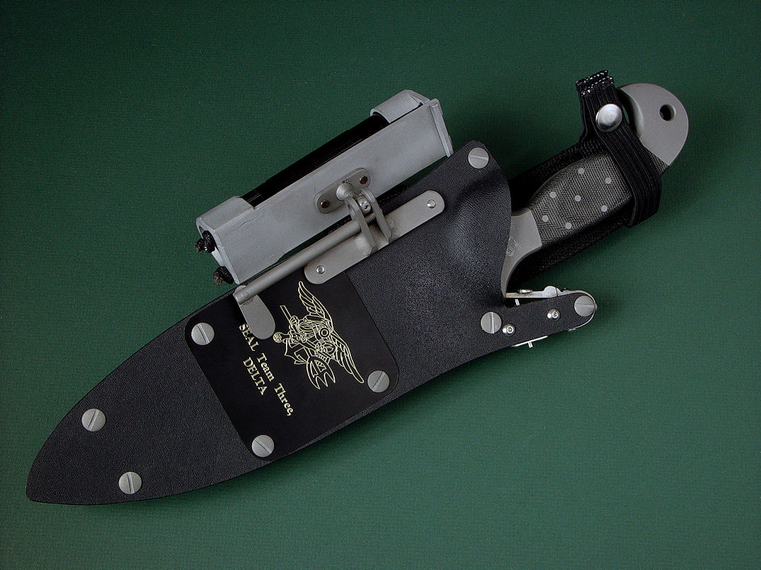 "Horus" obverse side view in ATS-34 high molydenum stainless steel blade, 304 stainless steel bolsters, engraved, Micarta phenolic handle, locking kydex, aluminum, stainless steel sheath with black lacquered brass engraved flashplate.