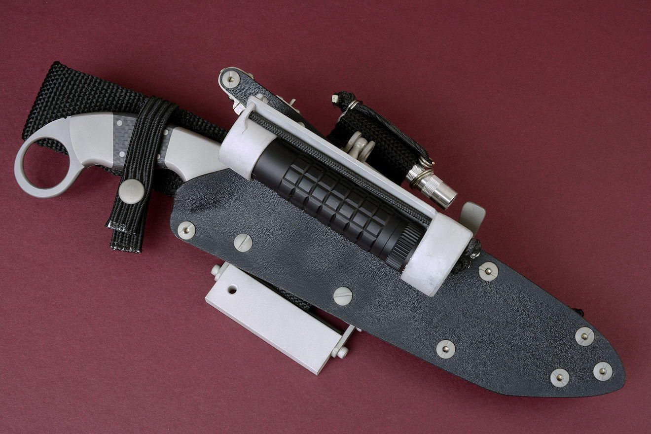 "Raijin" Tactical combat knife, obverse side view in CPMS30V high vanadium stainless tool steel blade, 304 stainless steel bolsters, carbon fiber handle, locking sheath in kydex, aluminum, stainless steel with Ultimate belt loop extender package and all accessories