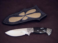 "Chama" obverse side view in 440C high chromium stainless steel blade, hand-engraved low carbon steel bolsters, snowflake obsidian gemstone handle, emu skin inlaid in hand-carved leather sheath