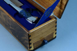 "Concordia" Master Chef's Custom Knife, case end and drawer pull details, in 440C deep cryogenically treated high chromium stainless steel blade, 304 stainless steel bolsters, Sodalite gemstone handle, silicone prise, case of American Black Walnut hardwood, diamond pad sharpener with silicone prise, engraved black lacquered brass, all stainless steel hinges and screws
