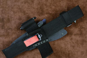 "Contego" Counterterrorism Tactical Knife, sheathed view with UBLX, open, removal of sharpener, in T3 cryogenically treated CPM154CM  powder metal technology high molybdenum martensitic stainless steel blade, 304 stainless steel bolsters, Black/Gray G10 fiberglass/epoxy composite handle, hybrid tension tab-locking sheath in kydex, anodized aluminum, stainless steel, titanium