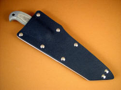 "PJFZ" USAF Pararescue CSAR knife, sheathed view. Stout sheath leaves enough of hawk's bill to pull knife, yet protects wearer and knife securely.