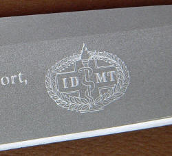 "PJ" reverse side IDMT crest engraving details on bead blasted, hollow ground high chromium stainless tool steel blade
