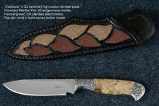 "Vulpecula" obverse side view in D2 extremely high carbon die steel blade, hand-engraved 304 stainless steel bolsters, Petrified Fern fossil gemstone handle, hand-carved leather sheath inlaid with rayskin
